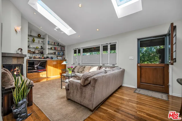 a living room with furniture a large window with outer view