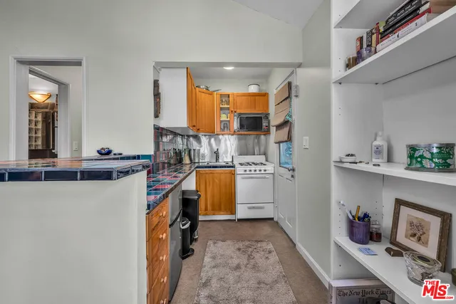 a kitchen with a refrigerator and a stove