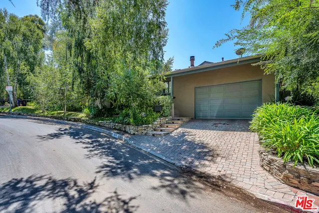 a front view of a house with a yard and a garage