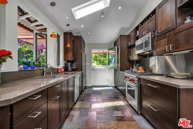 a kitchen with stainless steel appliances granite countertop a stove and a sink