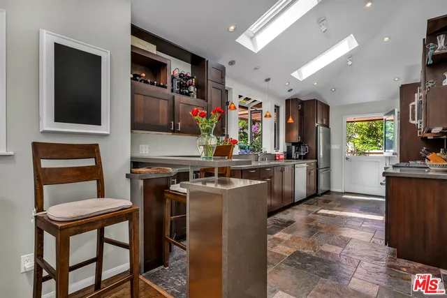 a kitchen with a stove a refrigerator and a dining table