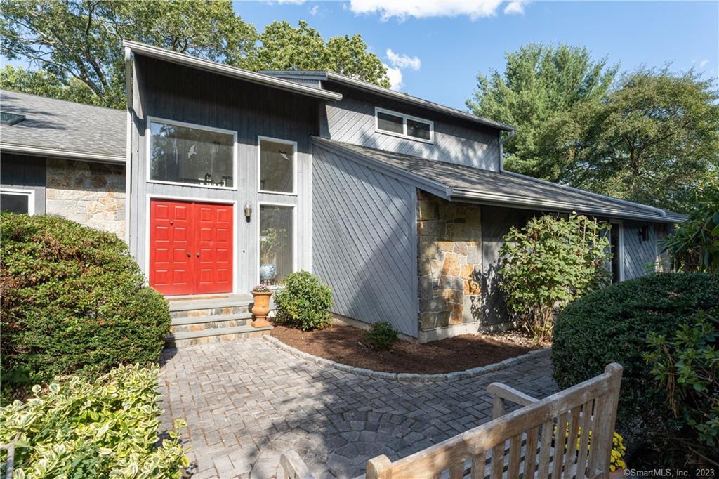 Pretty stone pavers lead you to the front entryway of this special residence.