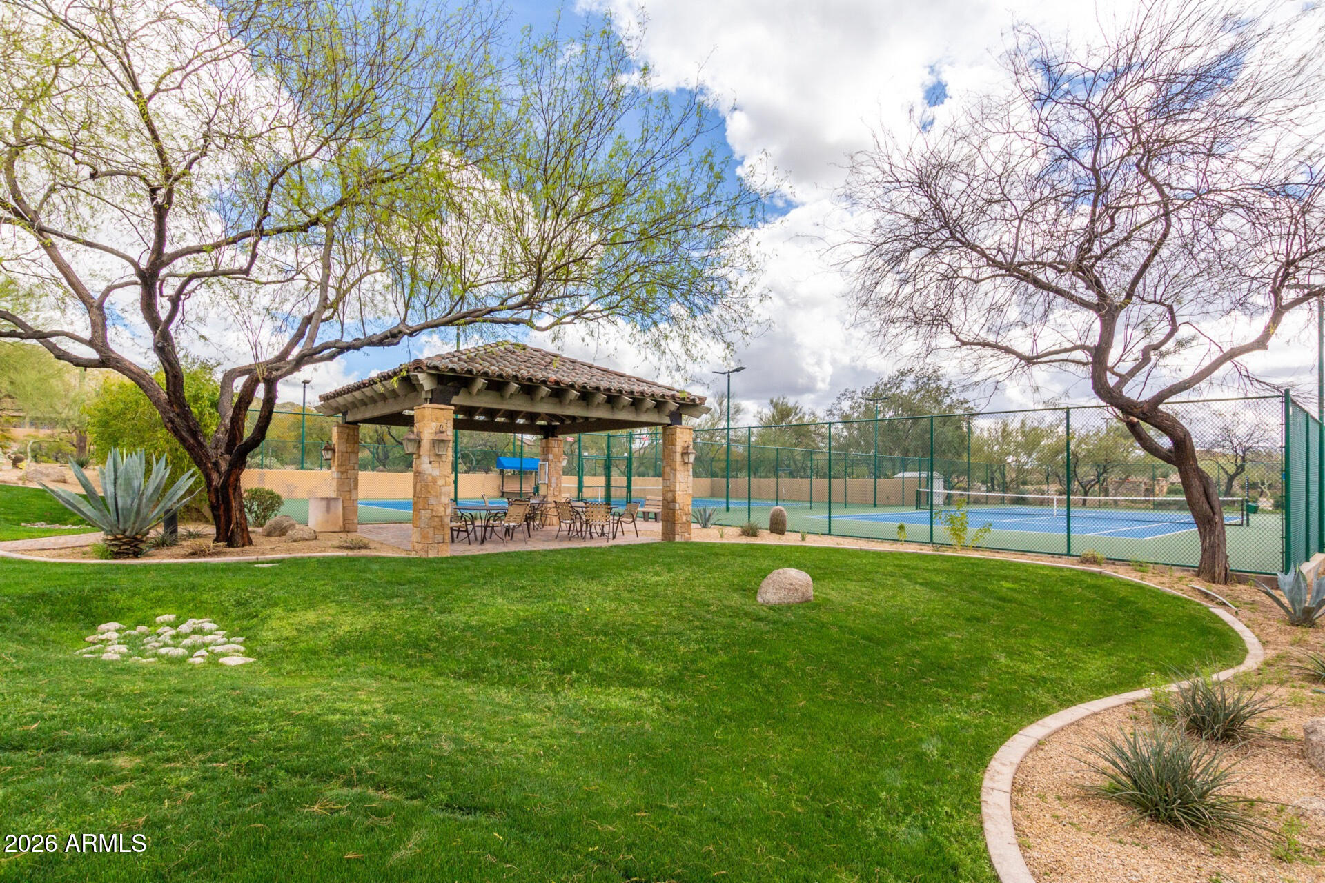3430 North Mountain Ridge, Unit 13 Mesa, AZ 85207 - Photo 116 of 124 a view of a swimming pool with a table and chairs under an umbrella