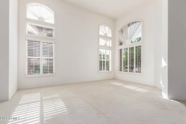 an empty room with fireplace and window