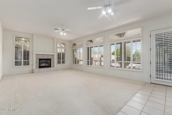 an empty room with closet and a ceiling fan