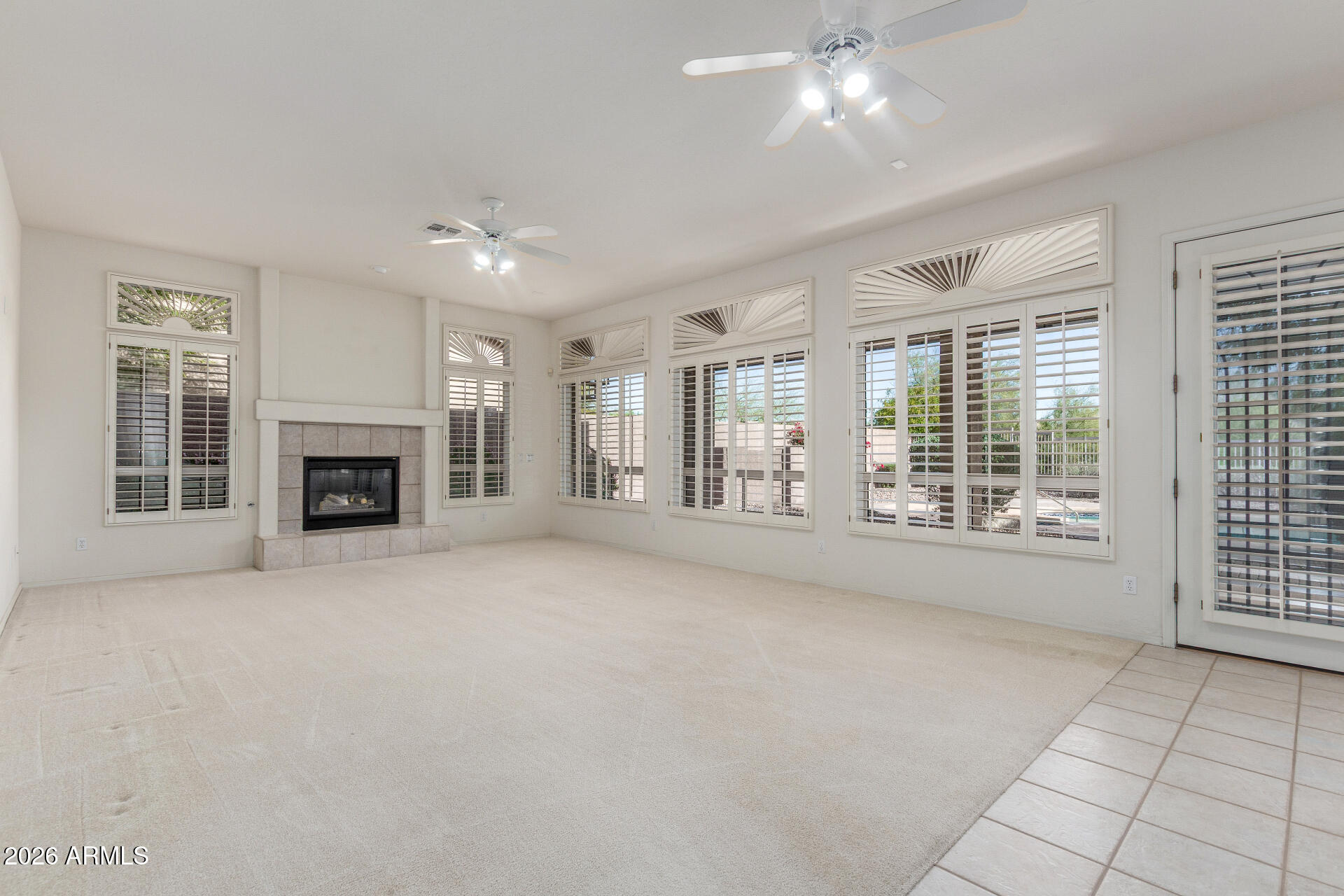 3430 North Mountain Ridge, Unit 13 Mesa, AZ 85207 - Photo 25 of 115 a view of an empty room with a fireplace and a window