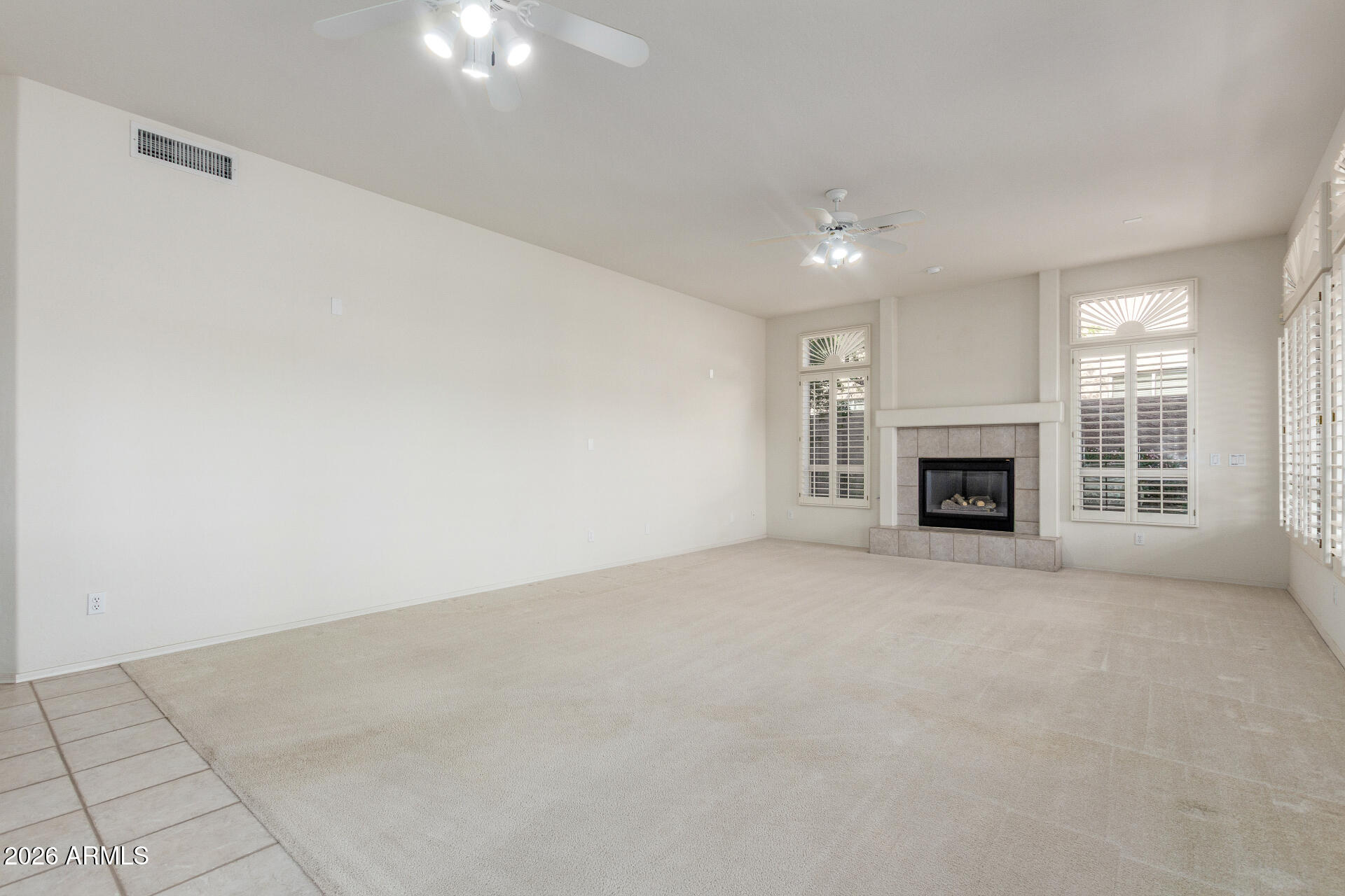 3430 North Mountain Ridge, Unit 13 Mesa, AZ 85207 - Photo 26 of 115 an empty room with fireplace and window