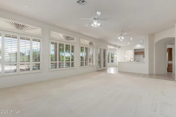 a view of an empty room with a fireplace and a large window