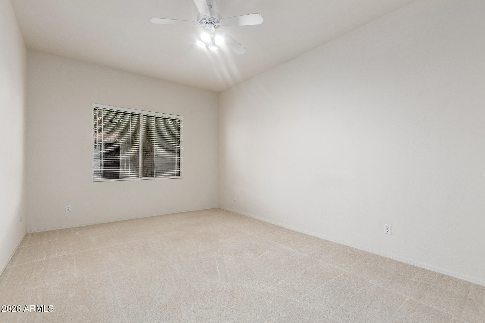 3430 North Mountain Ridge, Unit 13 Mesa, AZ 85207 - Photo 42 of 124 an empty room with a chandelier fan and windows
