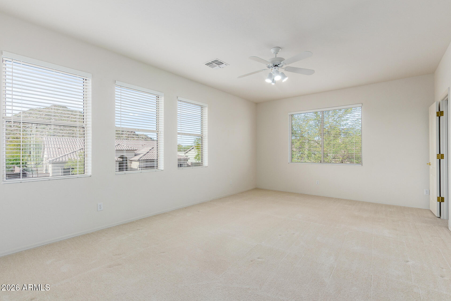 3430 North Mountain Ridge, Unit 13 Mesa, AZ 85207 - Photo 43 of 115 an empty room with windows and ceiling fan