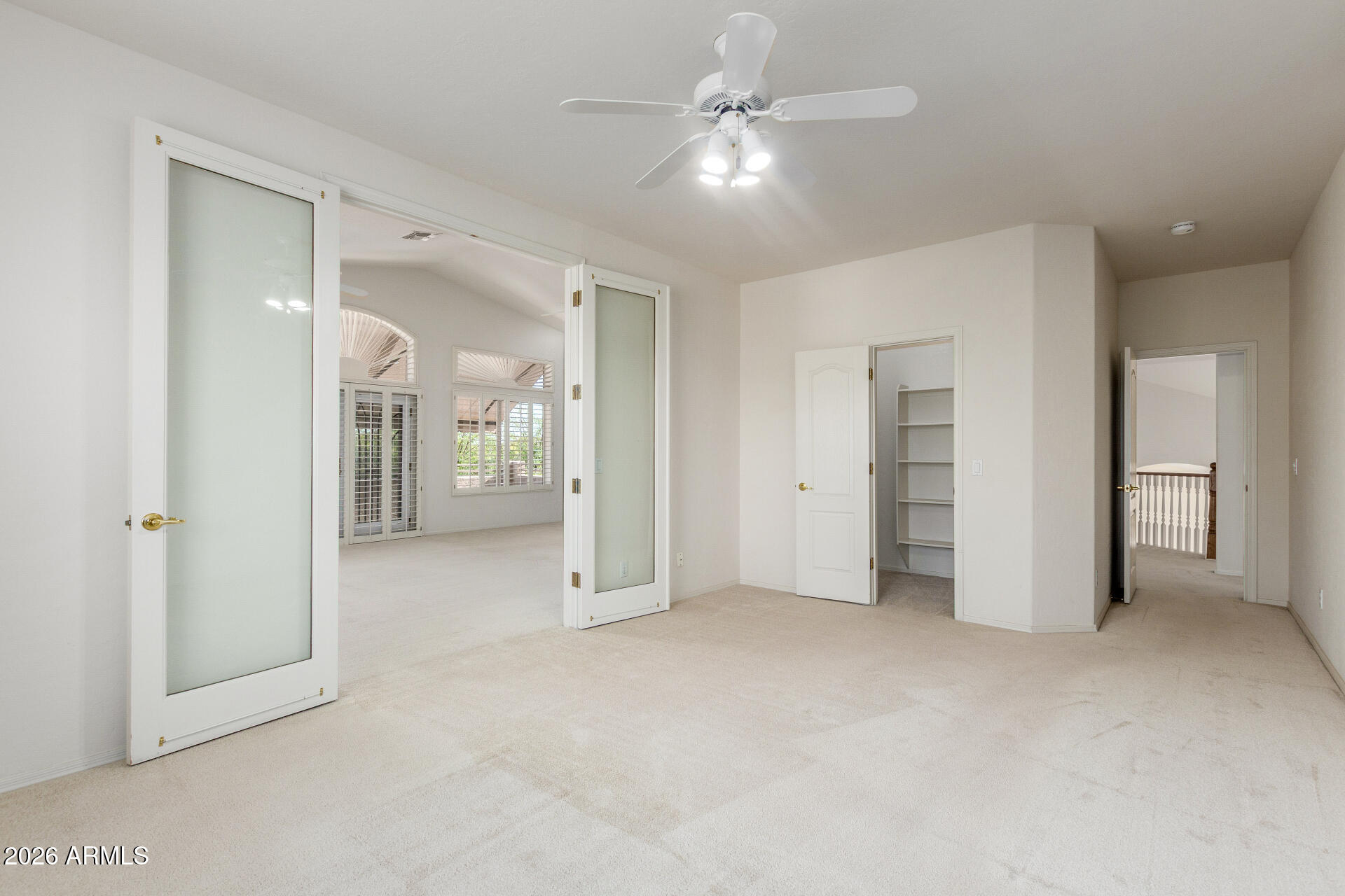 3430 North Mountain Ridge, Unit 13 Mesa, AZ 85207 - Photo 48 of 115 an empty room with closet and a ceiling fan