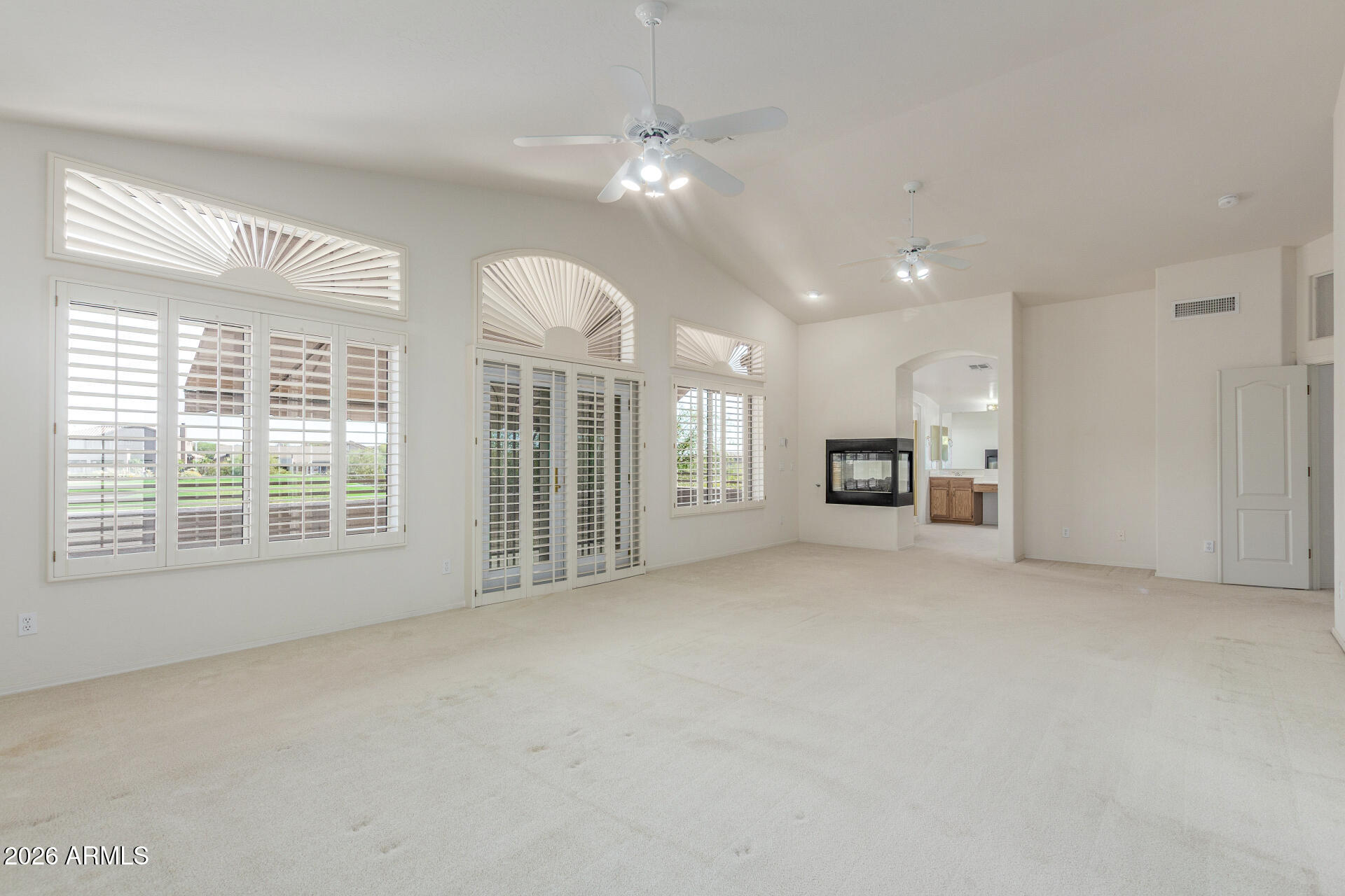 3430 North Mountain Ridge, Unit 13 Mesa, AZ 85207 - Photo 59 of 124 a view of an empty room with a fireplace and a large window