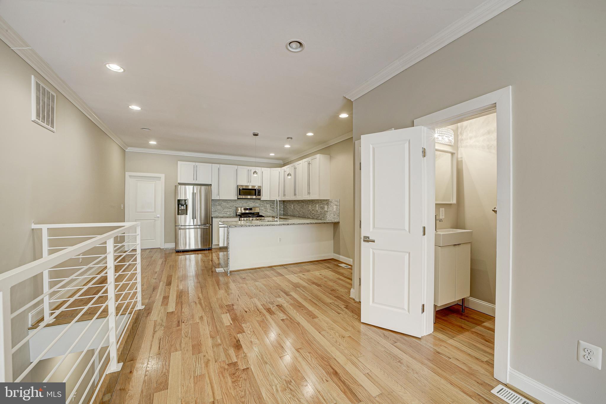 1926 1st Street Northwest, Unit 1 Washington, DC 20001 - Photo 12 of 37 a view of kitchen with wooden floor