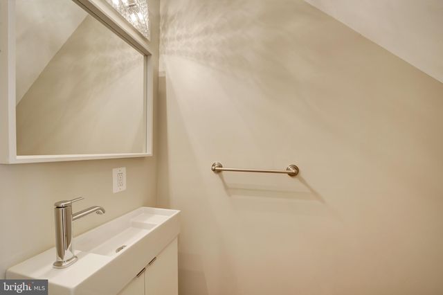 a bathroom with a sink and mirror