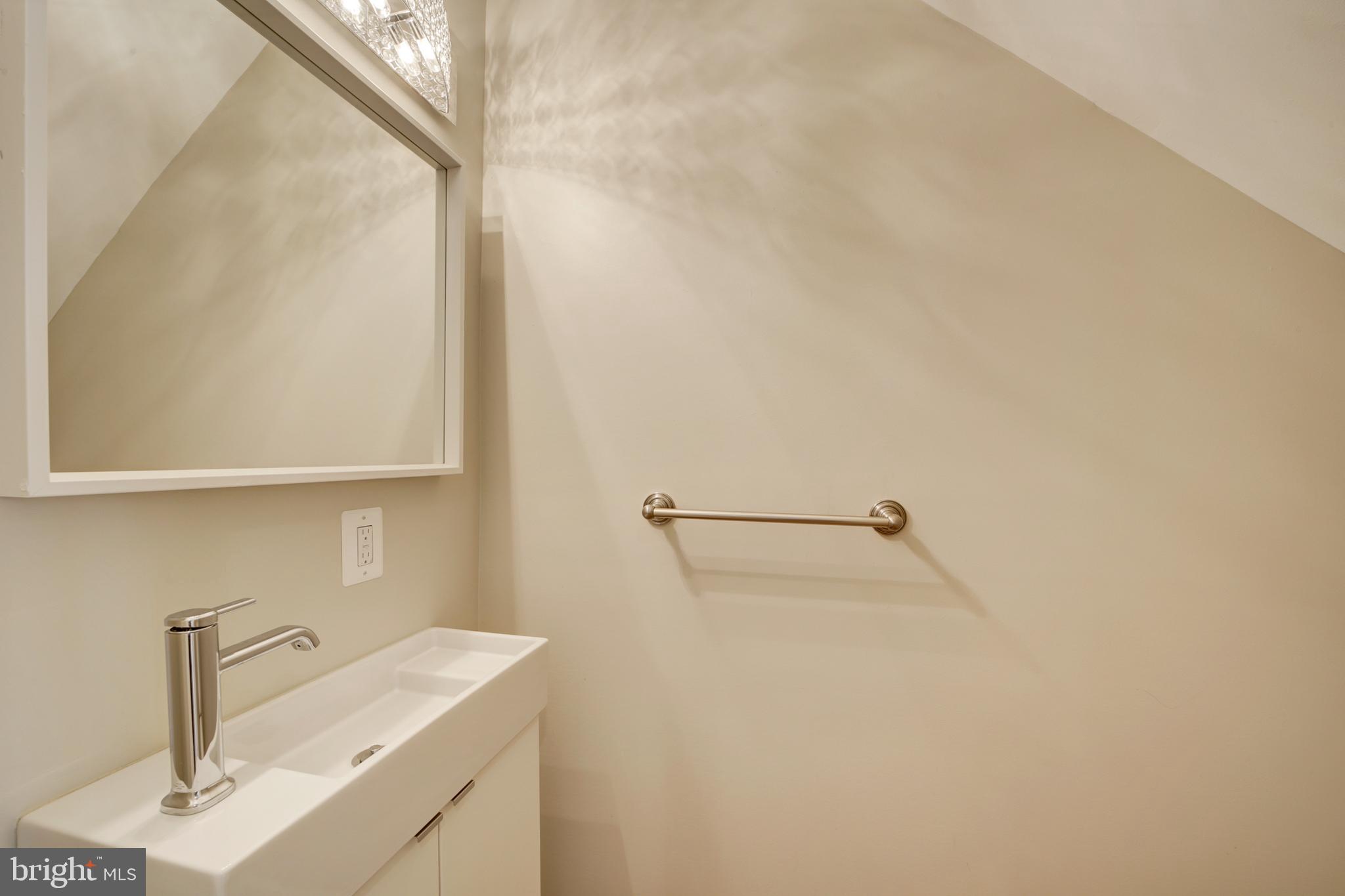 1926 1st Street Northwest, Unit 1 Washington, DC 20001 - Photo 17 of 37 a bathroom with a sink and mirror