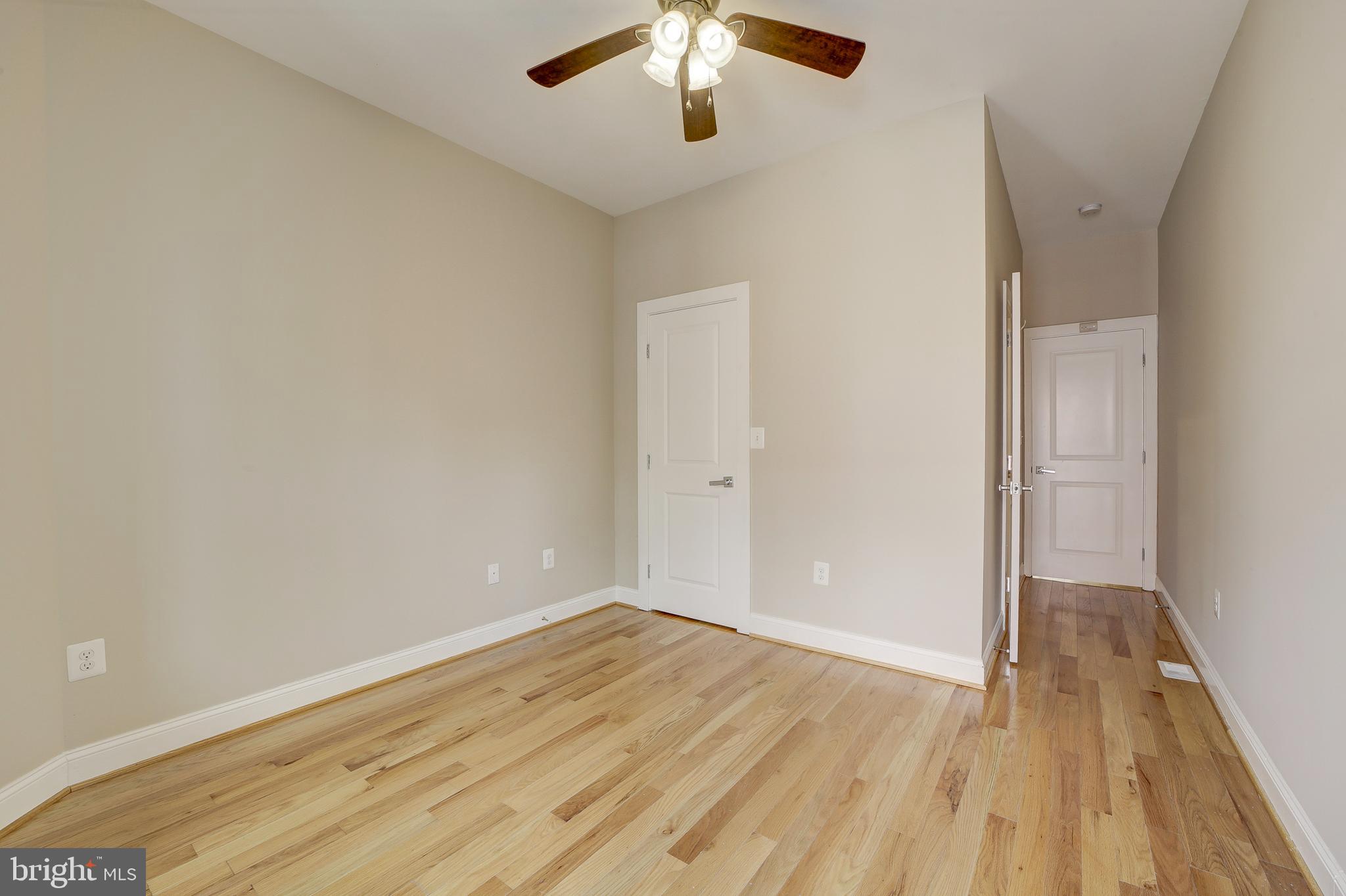 1926 1st Street Northwest, Unit 1 Washington, DC 20001 - Photo 19 of 37 wooden floor in an empty room with a window