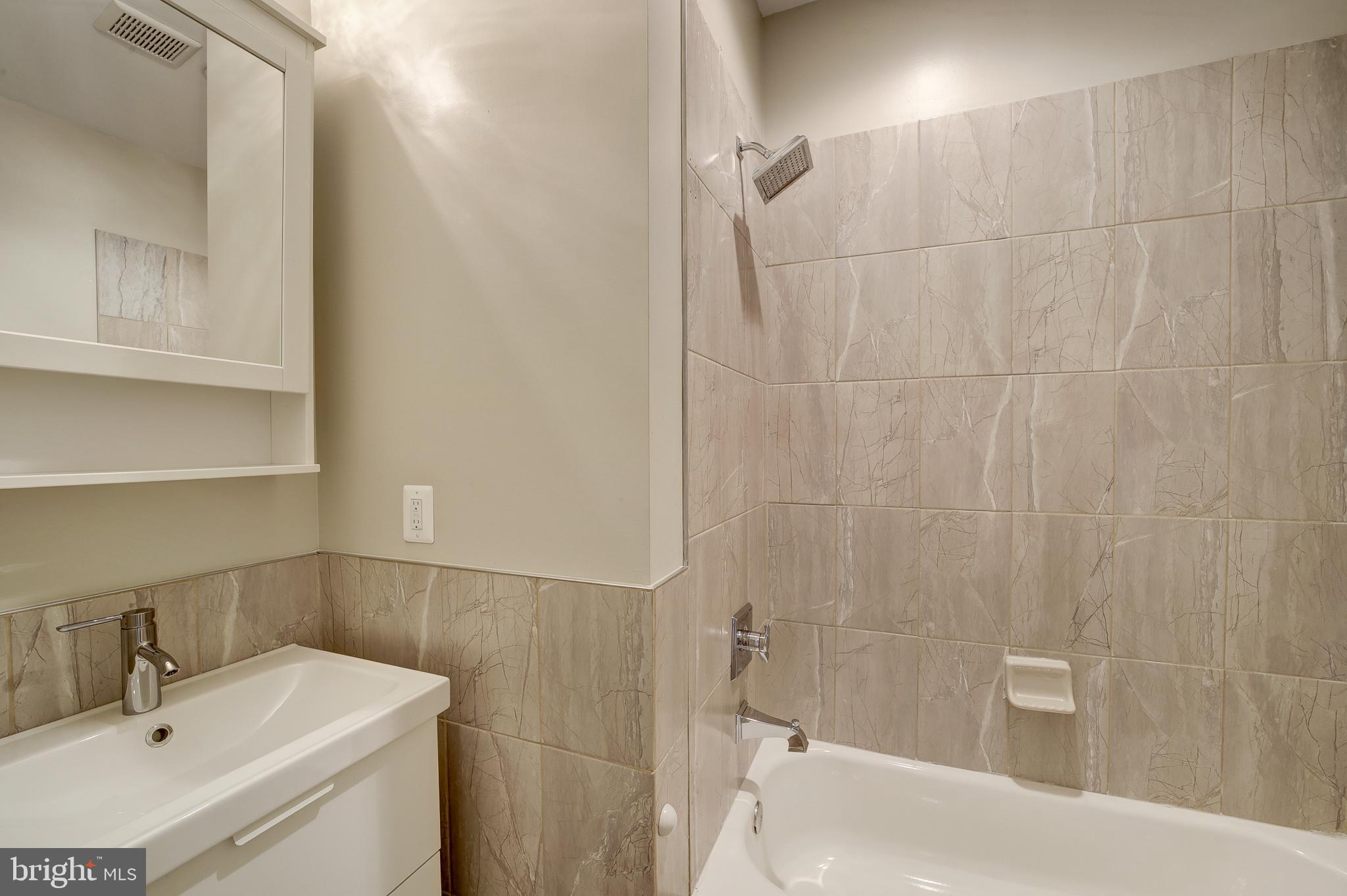 1926 1st Street Northwest, Unit 1 Washington, DC 20001 - Photo 21 of 37 a bathroom with a sink a toilet and shower