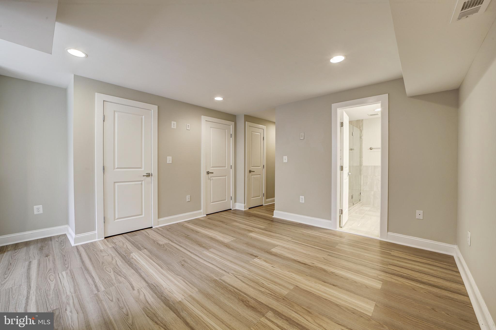 1926 1st Street Northwest, Unit 1 Washington, DC 20001 - Photo 22 of 37 a view of an empty room with wooden floor