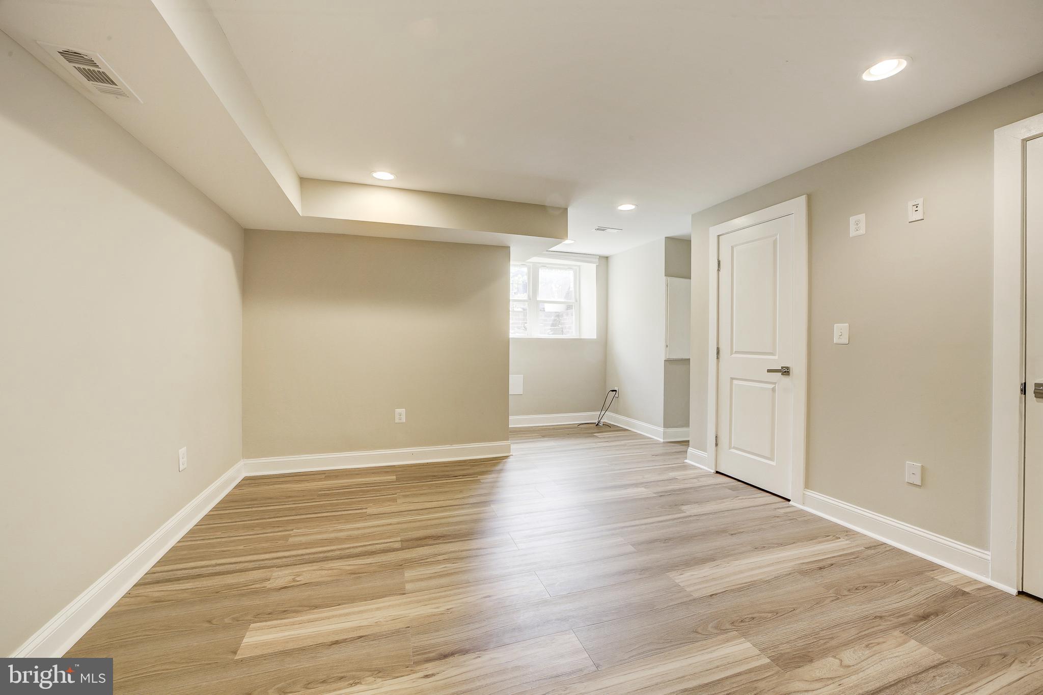 1926 1st Street Northwest, Unit 1 Washington, DC 20001 - Photo 23 of 37 a view of an empty room with wooden floor