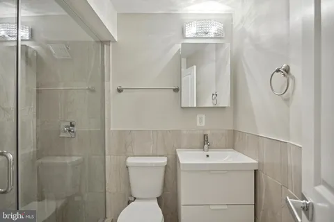 a white toilet sitting next to a bathroom sink
