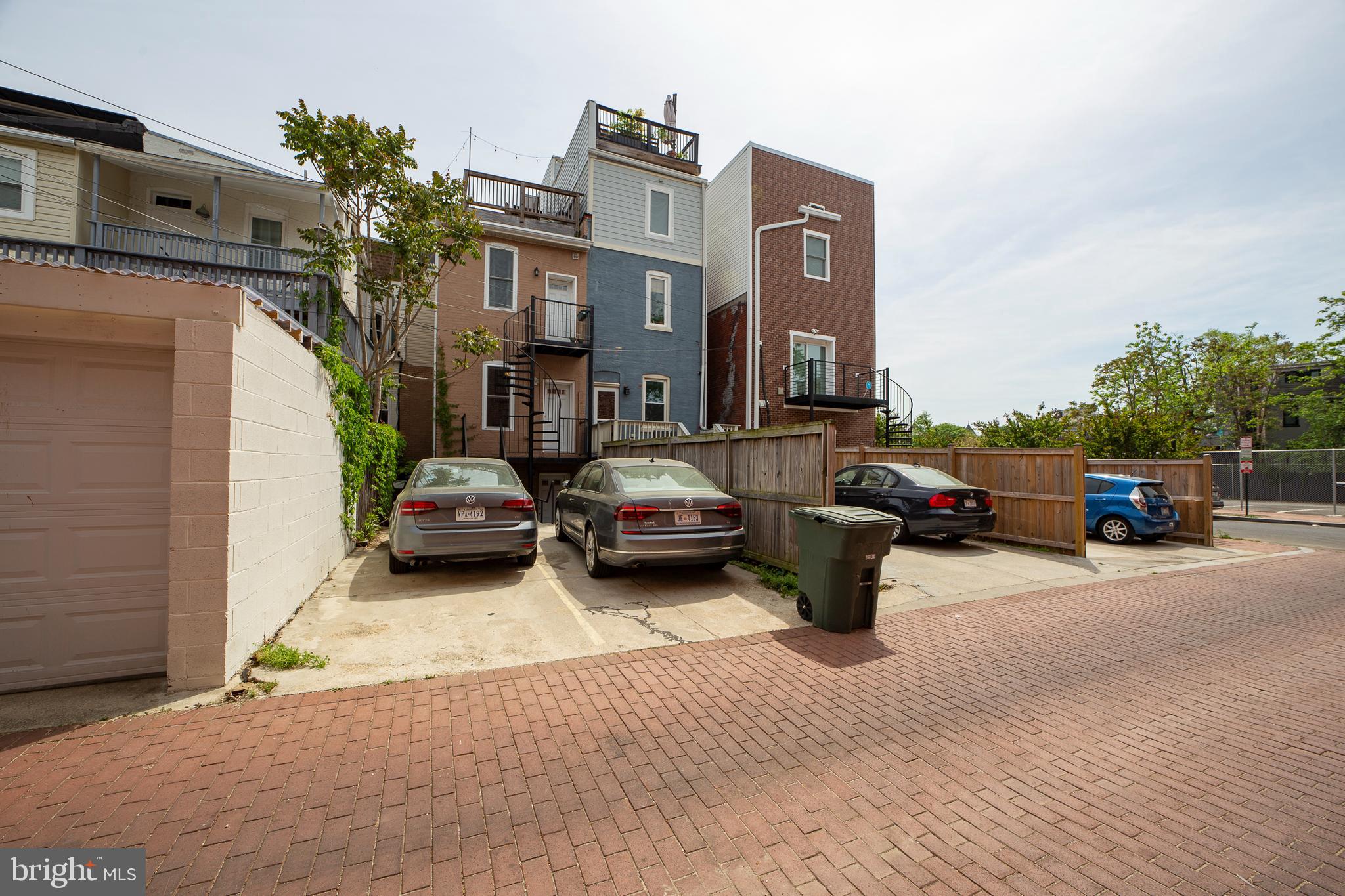 1926 1st Street Northwest, Unit 1 Washington, DC 20001 - Photo 32 of 37 a car parked in front of a brick house