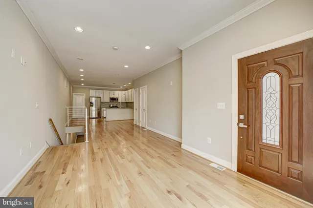 a view of empty room with wooden floor