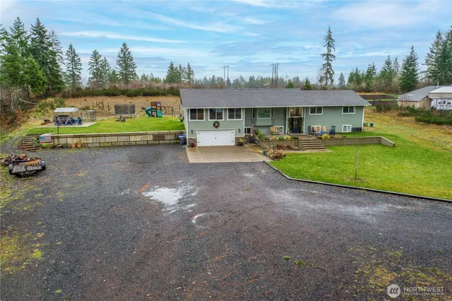 a view of a house with a yard and sitting area
