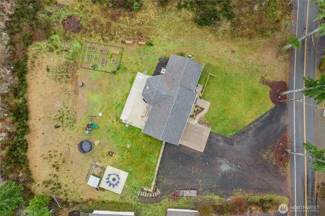 a front view of a house with a garden and trees