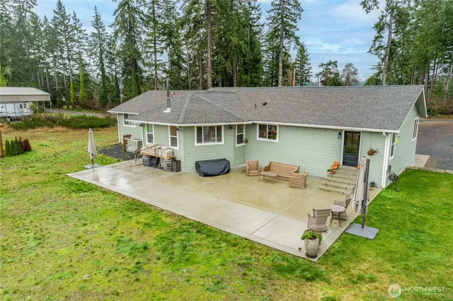 a view of a house with backyard porch and furniture