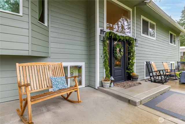 a view of a patio with a table and chairs and potted plants
