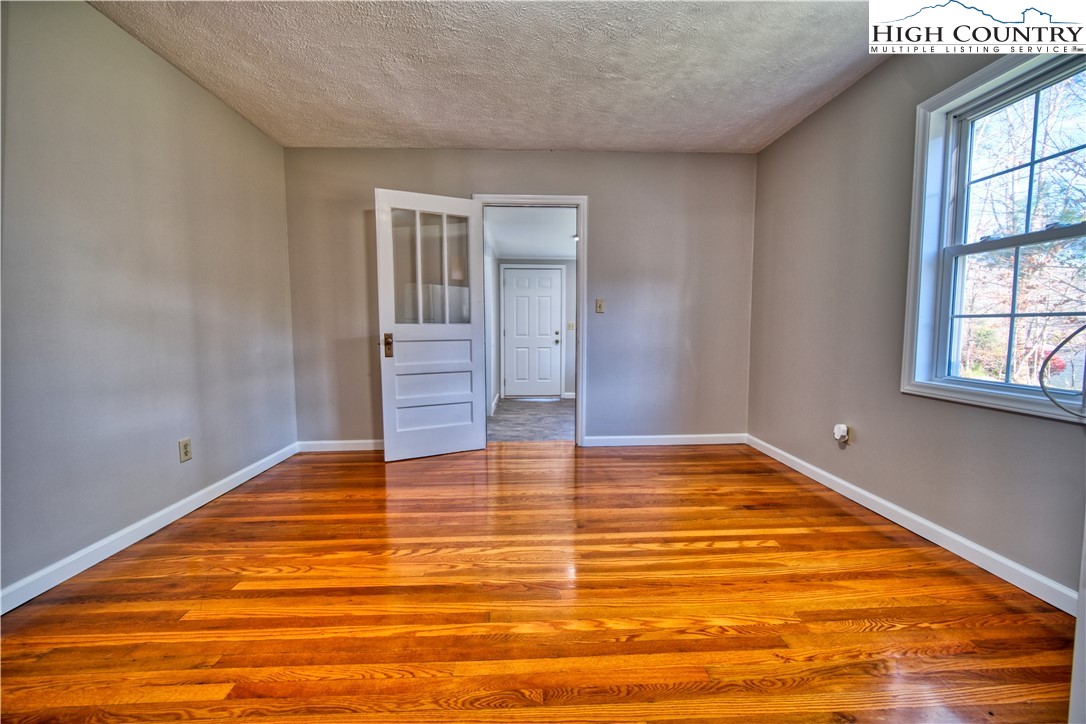 494 Frank Edwards Road West Jefferson, NC 28694 - Photo 12 of 27 a view of empty room with window and wooden floor