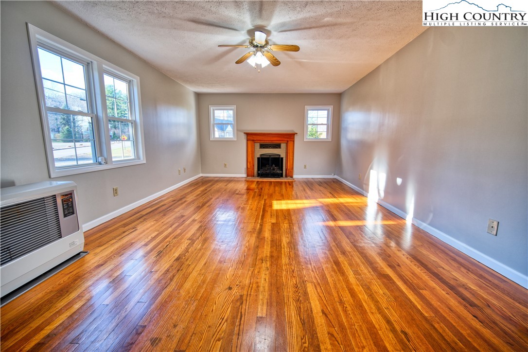 494 Frank Edwards Road West Jefferson, NC 28694 - Photo 7 of 27 a view of an empty room with window and wooden floor