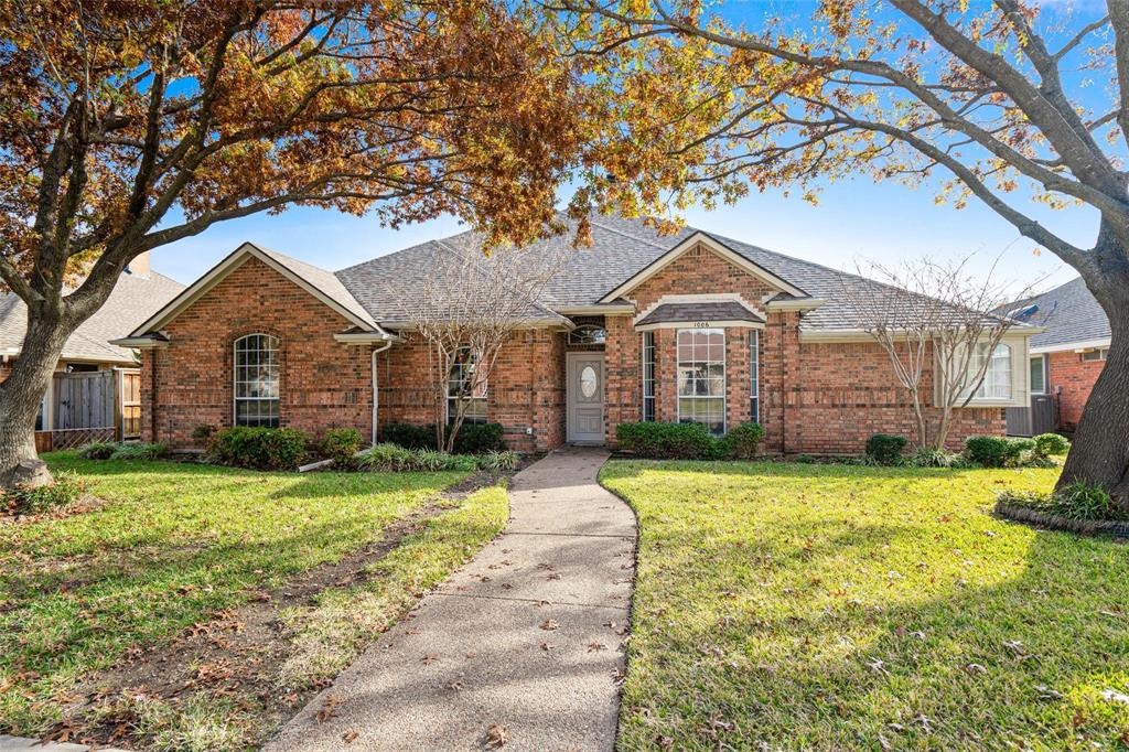 1006 Merribrook Lane Allen, TX 75002 - Photo 1 of 29 a front view of a house with a yard and garage