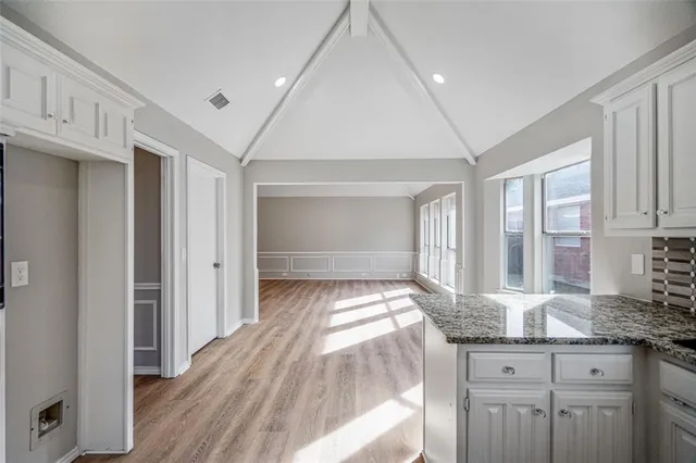 a hallway with granite countertop wooden floor