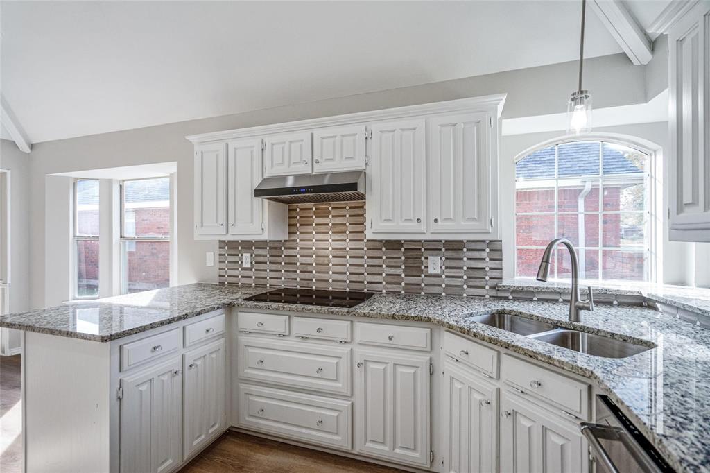 1006 Merribrook Lane Allen, TX 75002 - Photo 17 of 29 a kitchen with granite countertop a sink stainless steel appliances and cabinets