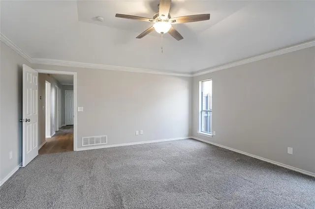 a view of an empty room and a ceiling fan window