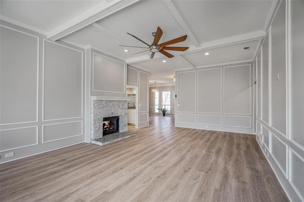 1006 Merribrook Lane Allen, TX 75002 - Photo 4 of 29 wooden floor fireplace and windows in an empty room