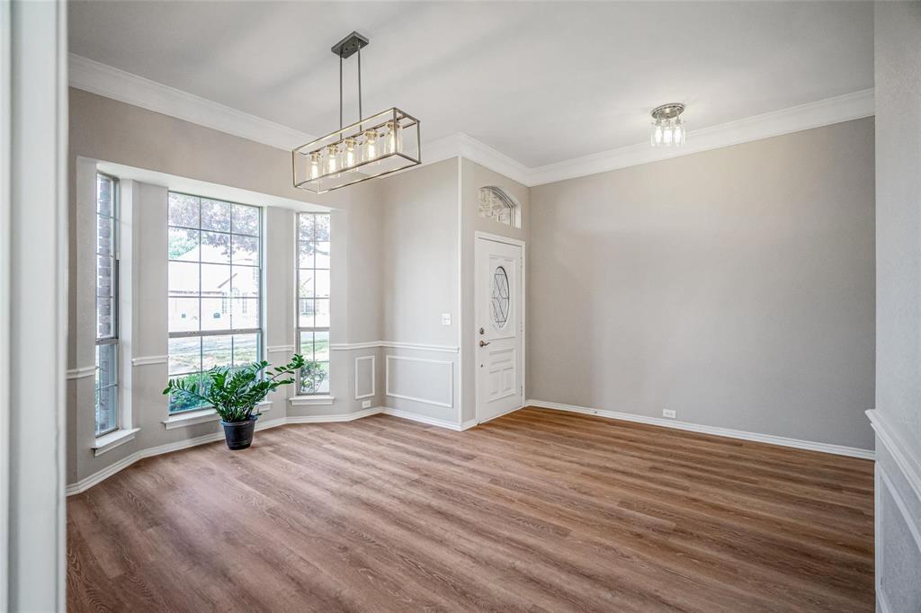 1006 Merribrook Lane Allen, TX 75002 - Photo 7 of 29 a view of an empty room with wooden floor and a window