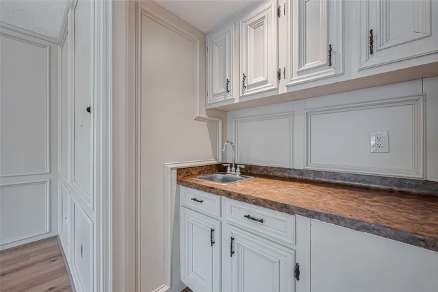 a bathroom with a sink and cabinets