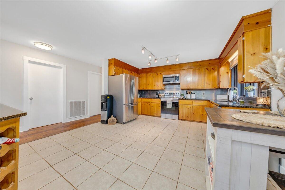 2800 Old Ferrum Road Ferrum, VA 24088 - Photo 15 of 58 a kitchen with stainless steel appliances granite countertop a sink and cabinets