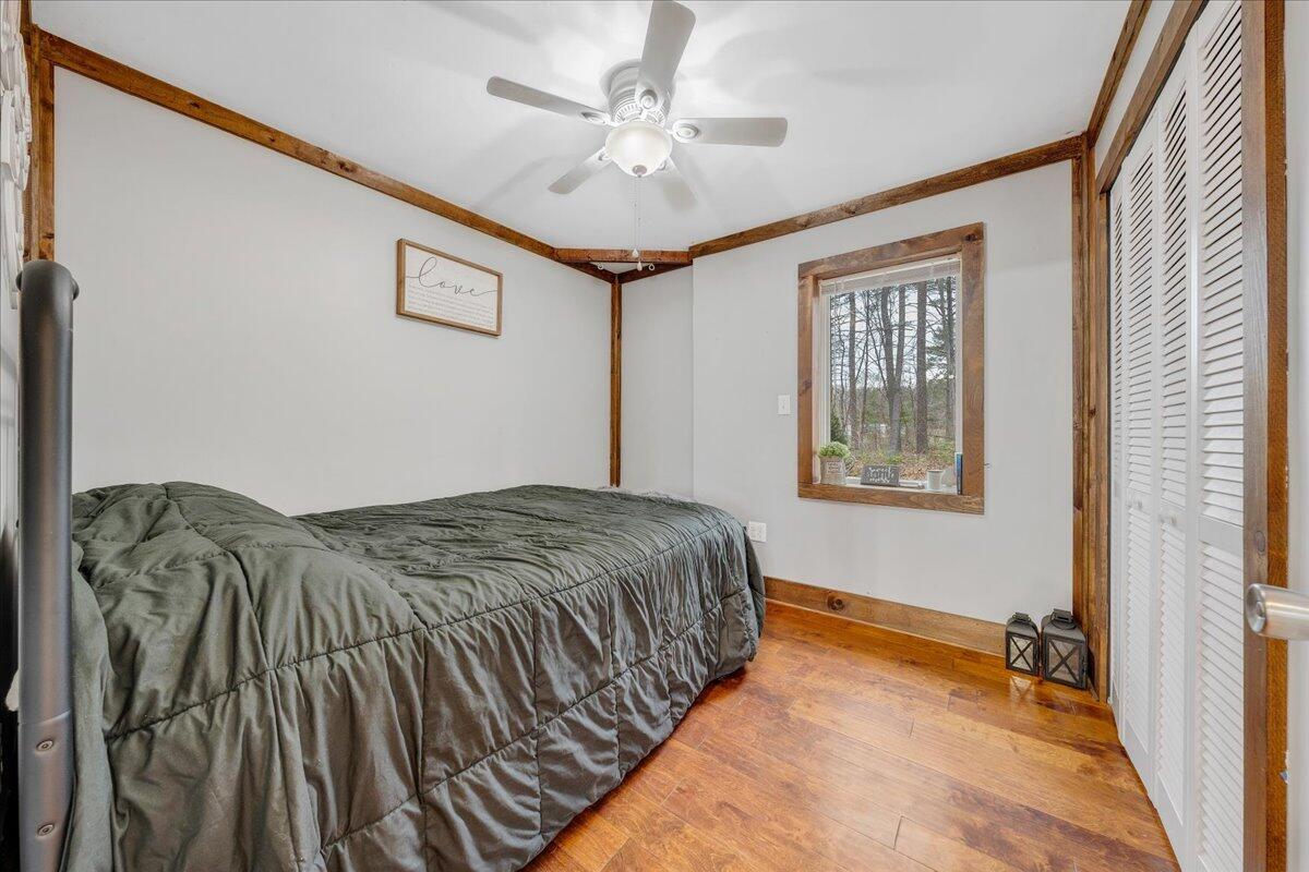 2800 Old Ferrum Road Ferrum, VA 24088 - Photo 20 of 58 a spacious bedroom with a bed and a chandelier