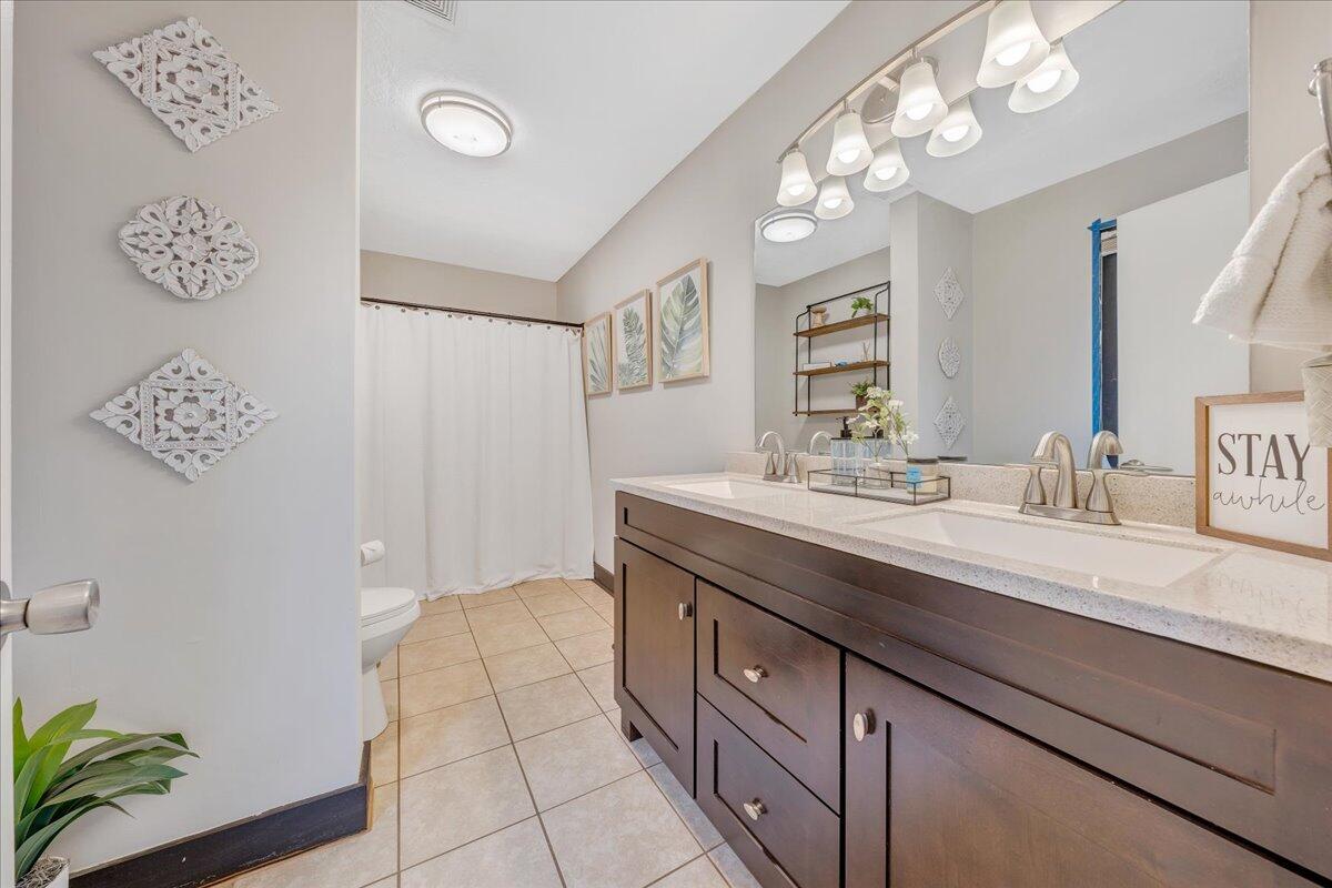 2800 Old Ferrum Road Ferrum, VA 24088 - Photo 23 of 58 a spacious bathroom with a granite countertop sink a mirror and a shower