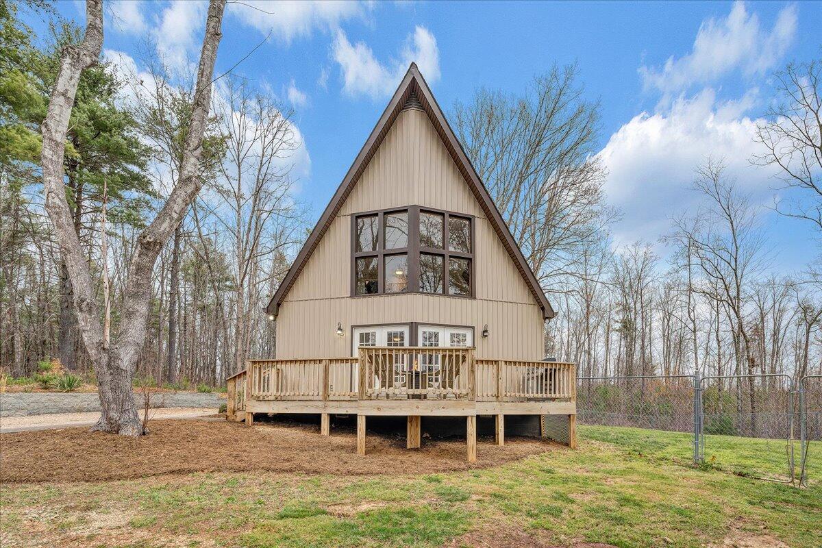 2800 Old Ferrum Road Ferrum, VA 24088 - Photo 5 of 58 a view of a house with a large window and a yard with plants
