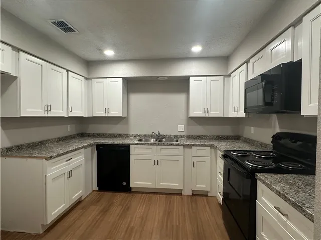 a view of livingroom hardwood floor and ceiling fan
