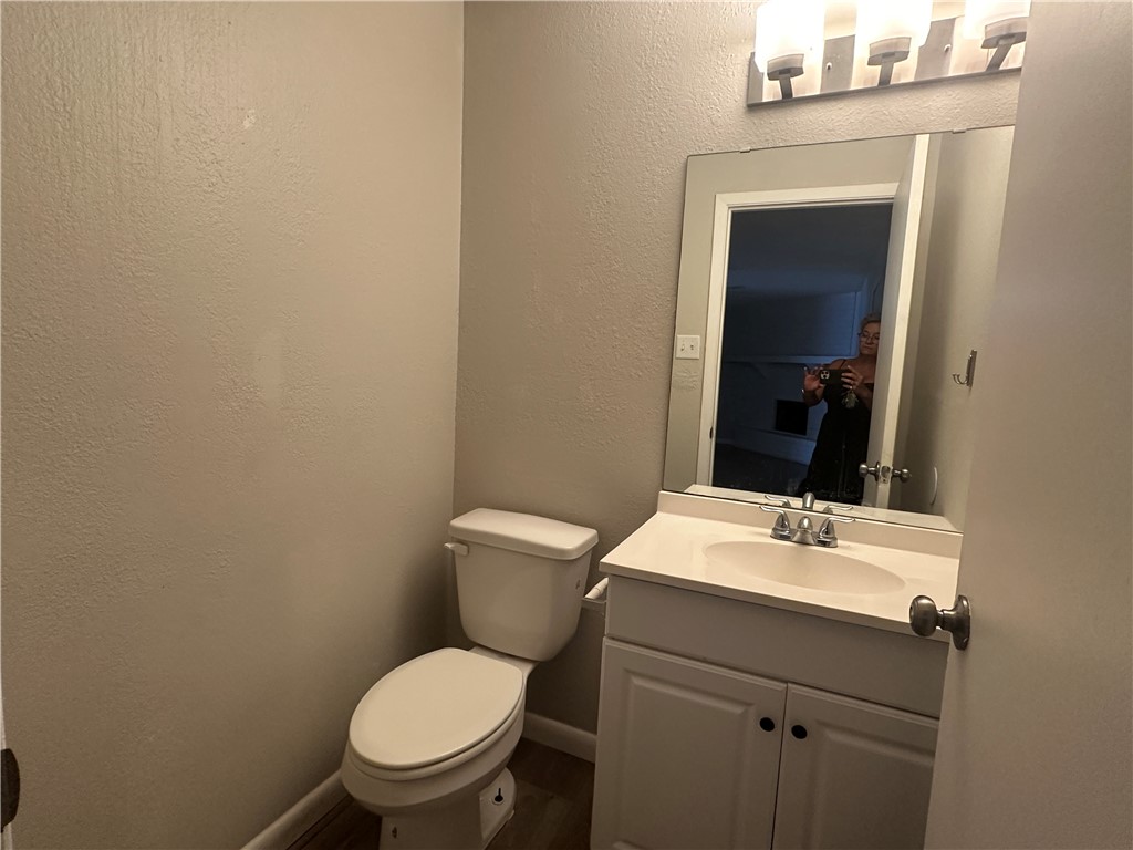 49 South Commonsway Drive, Unit 51 Portland, TX 78374 - Photo 7 of 12 a bathroom with a toilet sink and mirror