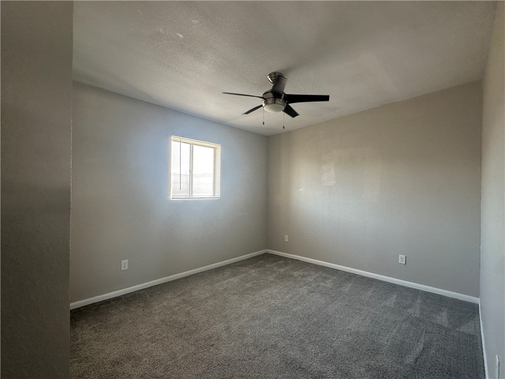 49 South Commonsway Drive, Unit 51 Portland, TX 78374 - Photo 9 of 12 en empty room with windows and ceiling fan