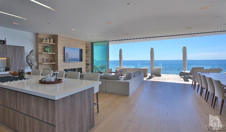 25236 Malibu Road Malibu, CA 90265 - Photo 4 of 33 a living room with couches and kitchen view with wooden floor