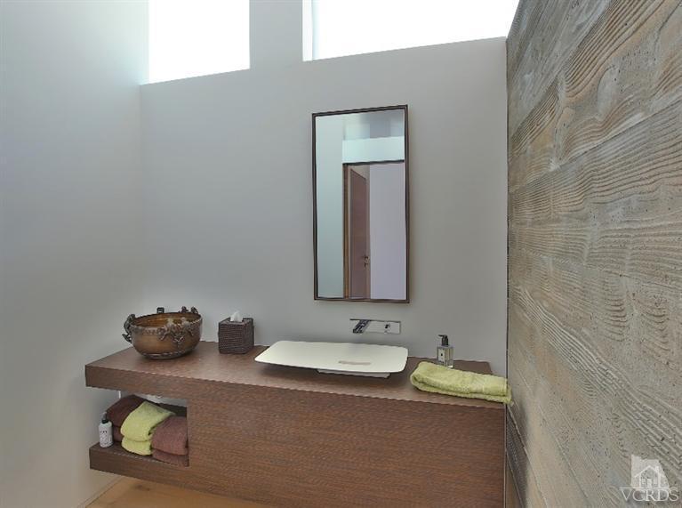 25236 Malibu Road Malibu, CA 90265 - Photo 32 of 33 a bathroom with a granite countertop sink and a mirror