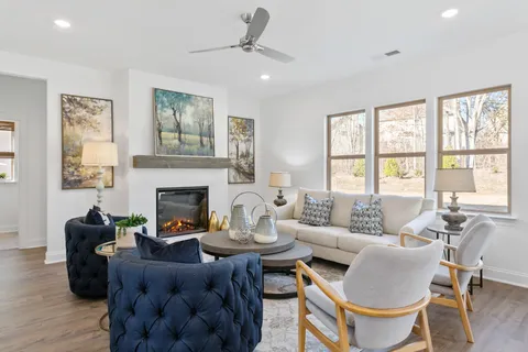 a living room with furniture fireplace and window