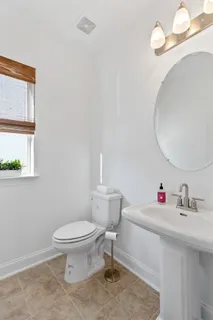 a bathroom with a sink toilet and a mirror